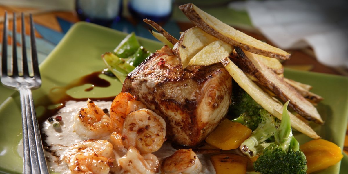 Galapagos seafood dish with shrimp and plantains on a green plate
