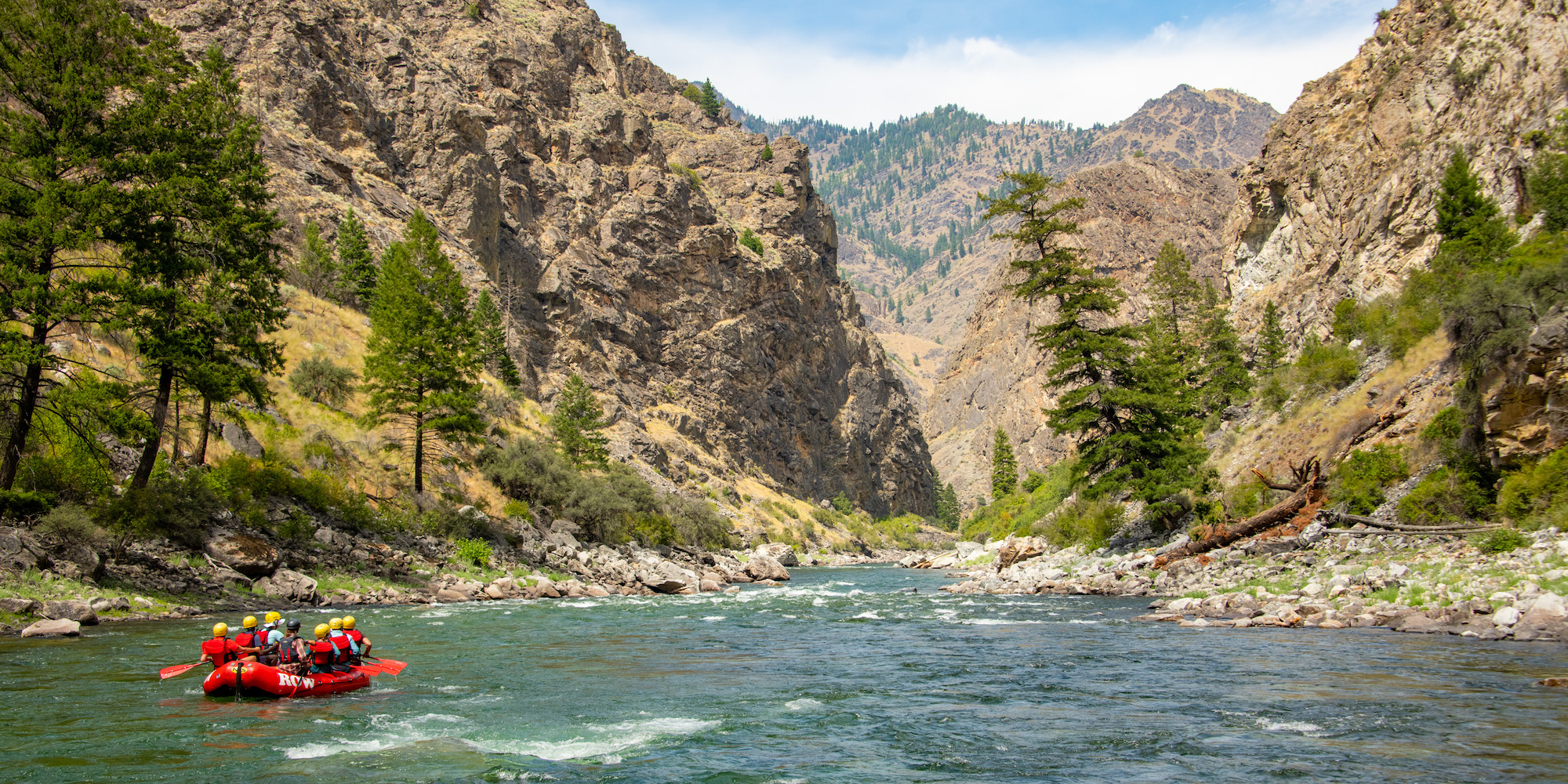 Looking downstream on a red raft floating the Middle Fork of the Salmon River through the Frank Church River of No Return Wilderness