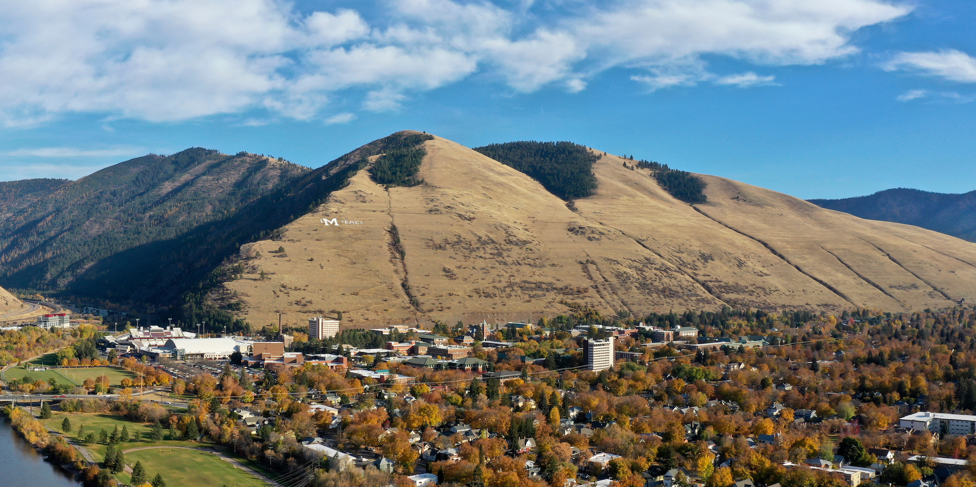Birds eye view of the University of Montana with the classic white 'M' on the hill behind it