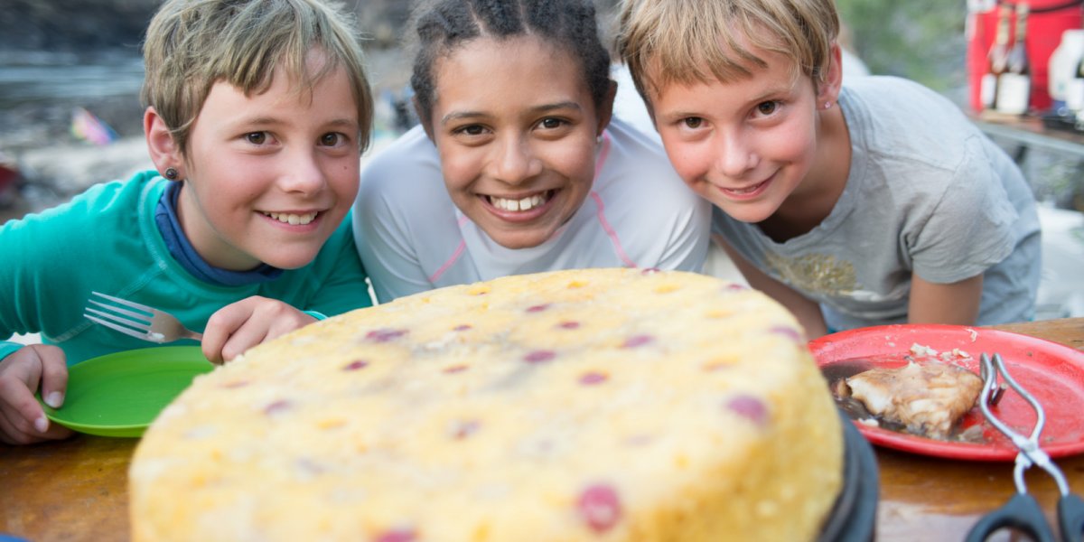 Young rafters await a much anticipated dutch oven pineapple upside-down cake for dessert