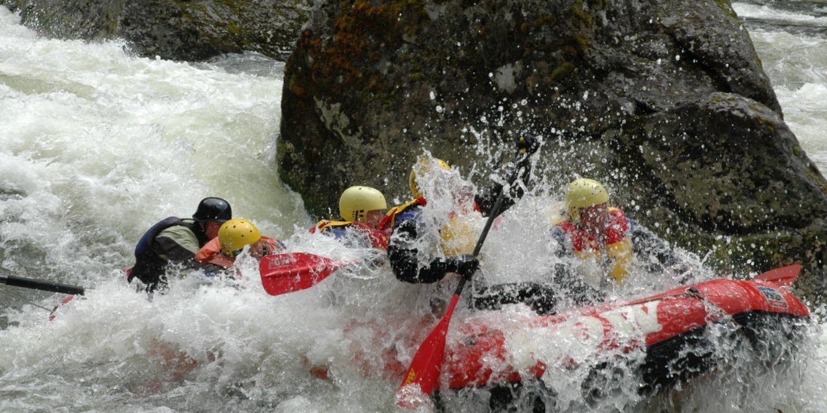 white water raft going through rapids