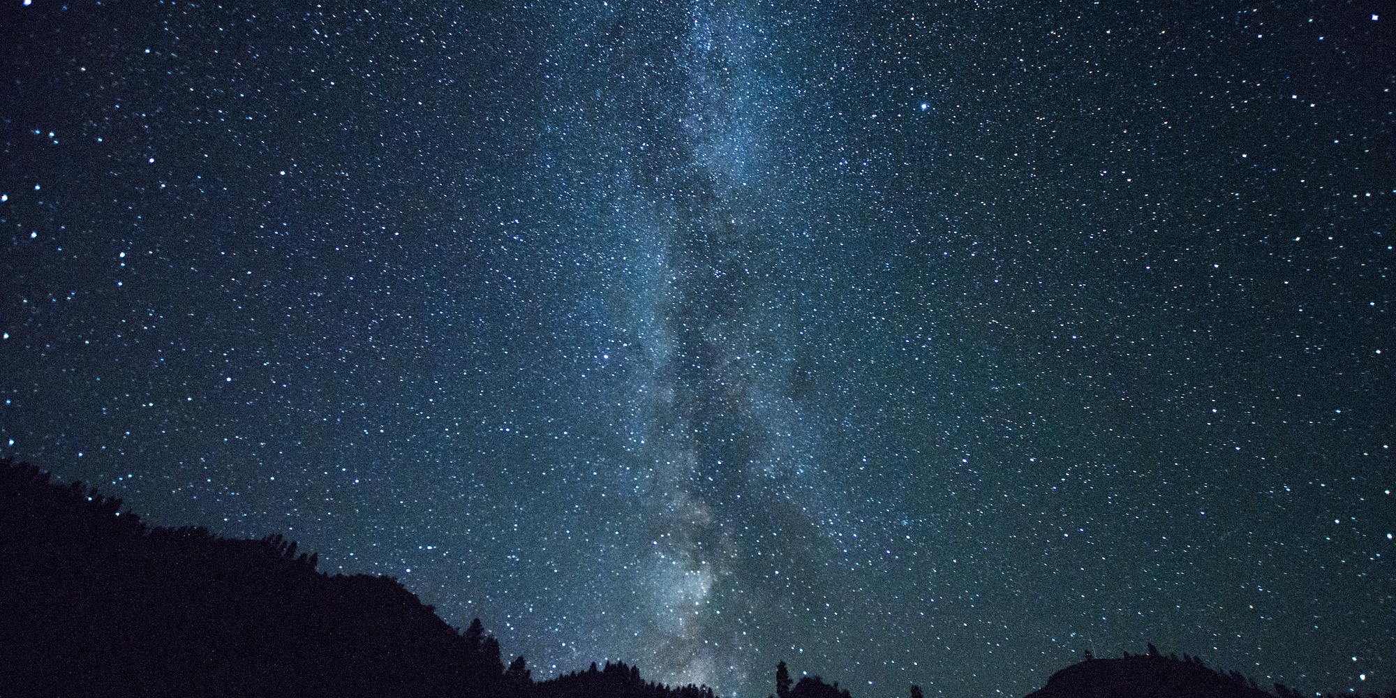 Milky Way and stars above rugged canyon walls during a remote stargazing trip in the river canyon.