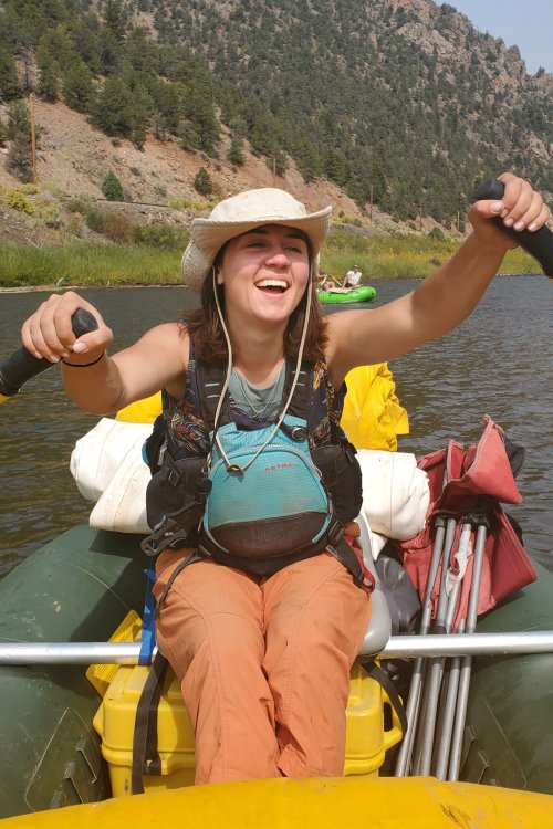 girl holding oars on river raft