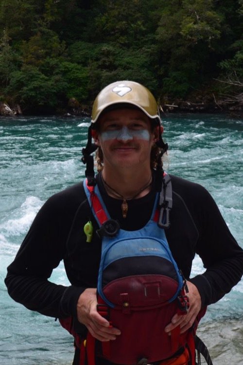 male river guide with hat and blue pfd