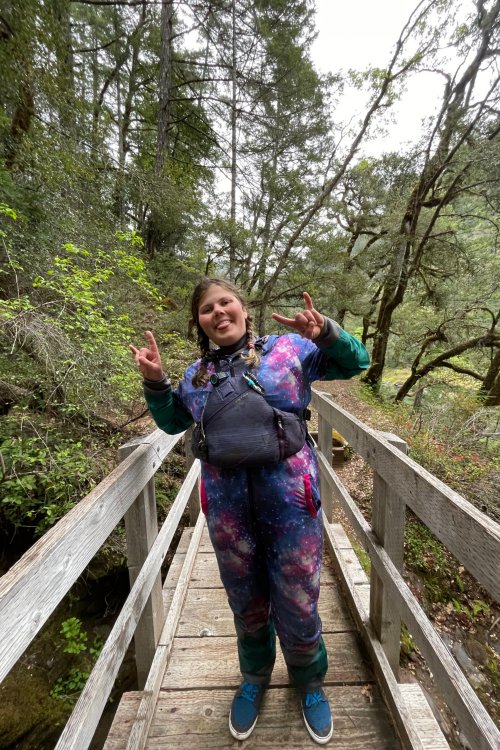 female river guide on wooden bridge