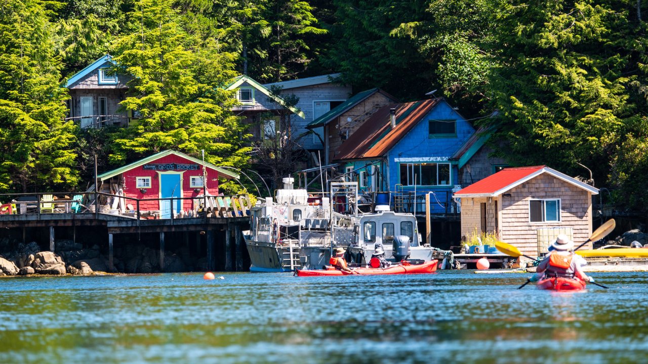 Sea kayakers paddling towards God's Pocket Resort in British Columbia