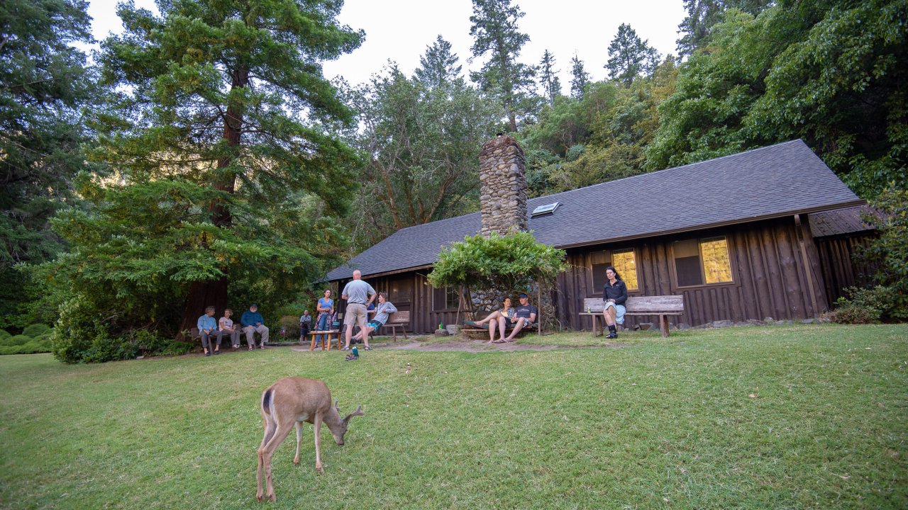 A deer and guests outside of Black Bar Lodge in Oregon