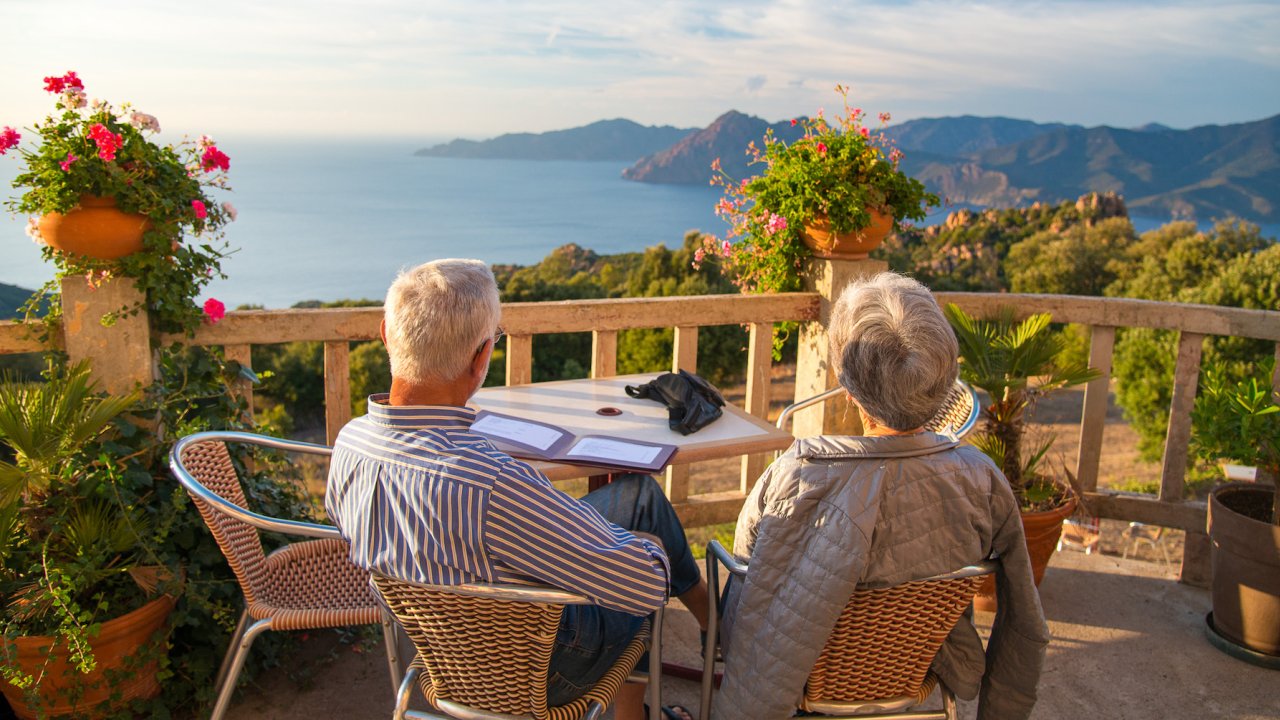 Couple eating at a restaurant overlooking the Mediterranean Sea 