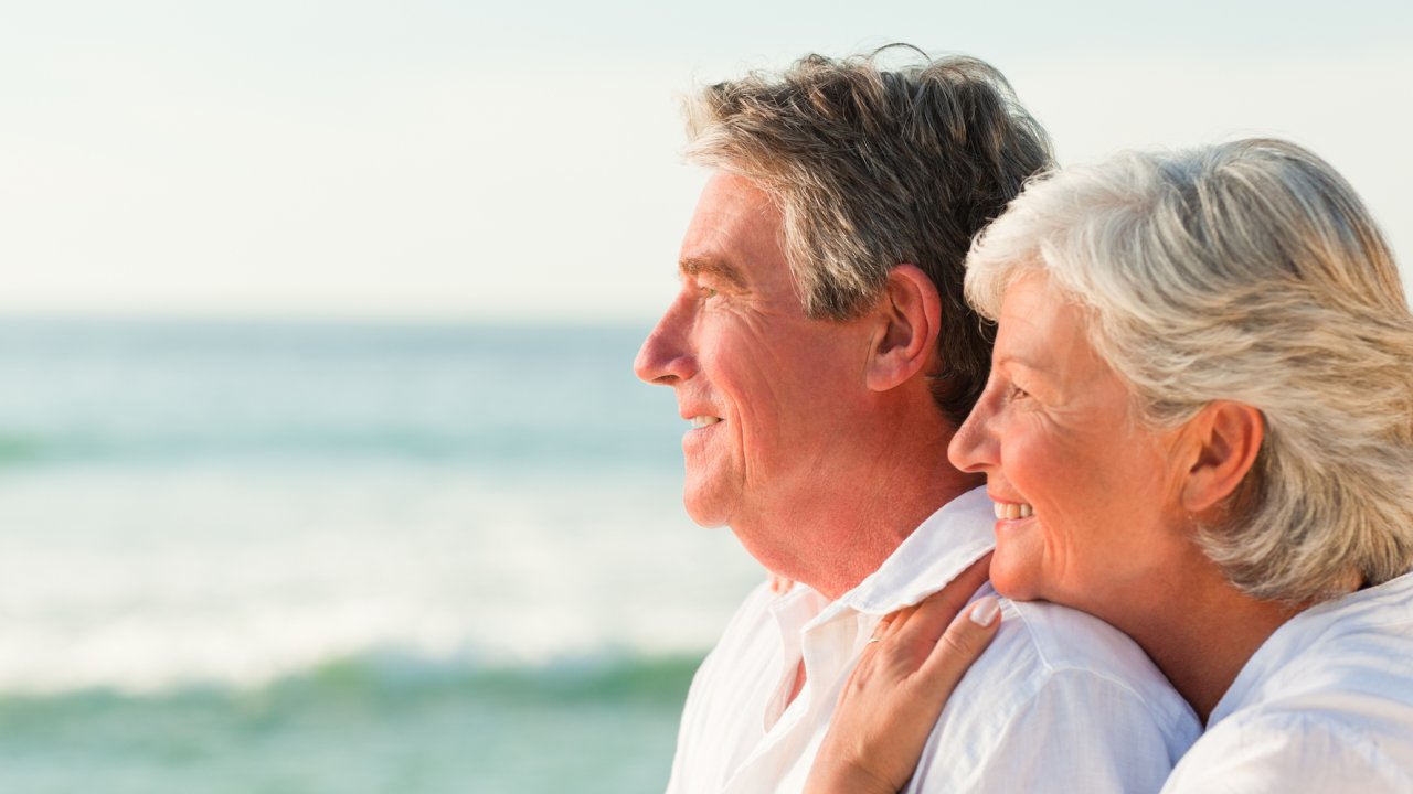 A couple smiling while on the water admiring the sunset