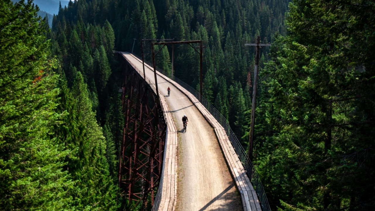 Smiling cyclists enjoying a guided Route of the Hiawatha biking tour in Idaho