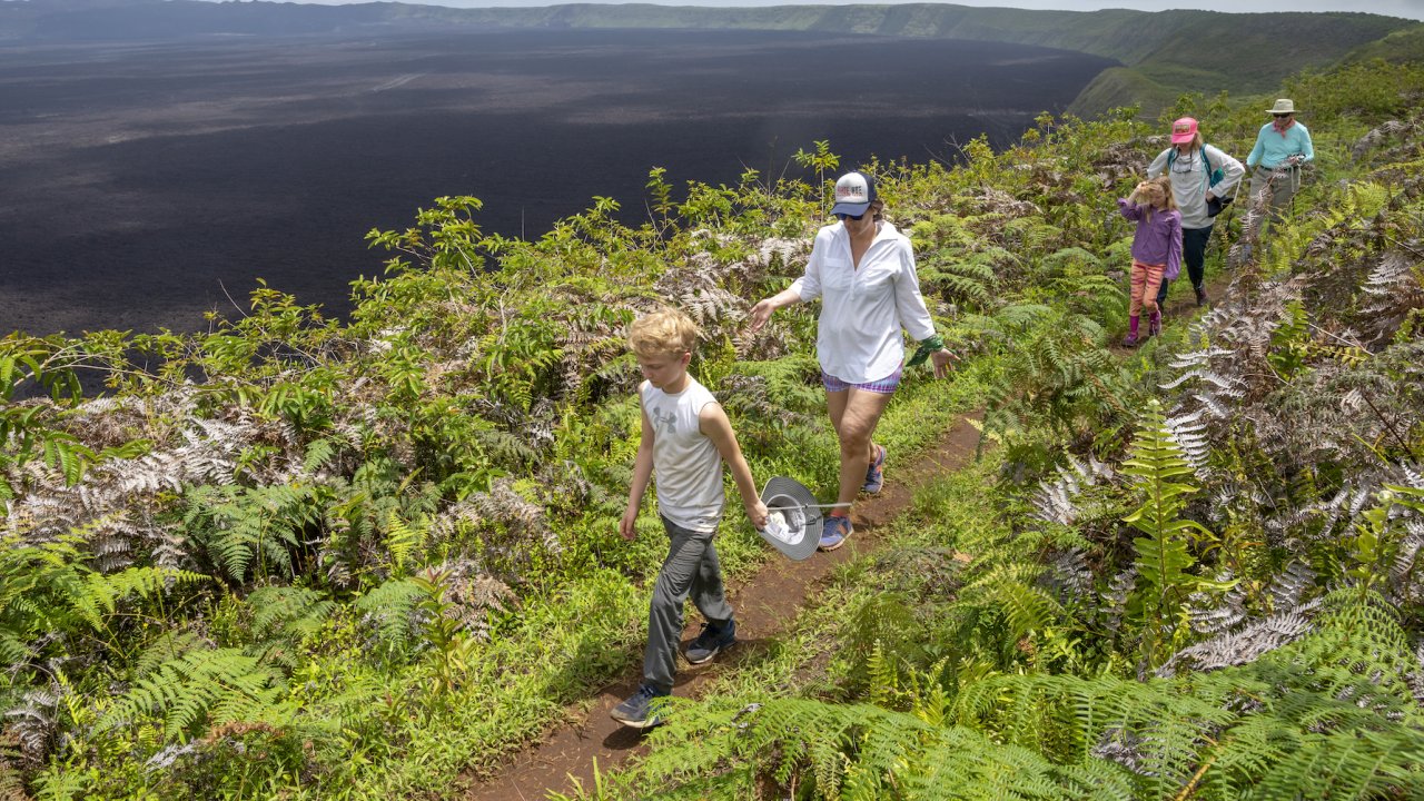 Family walking around a famous volcano in the Galapagos Islands