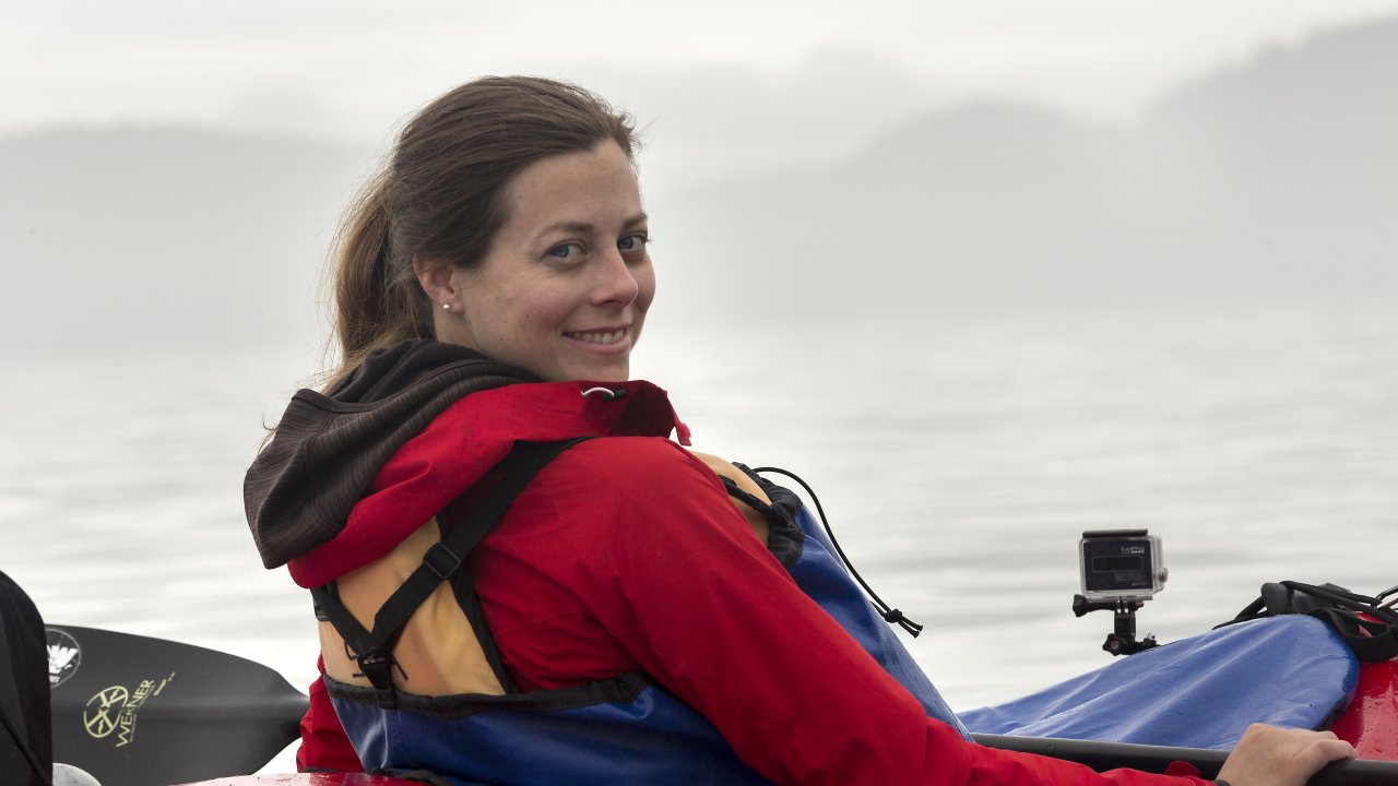 Sea kayaker smiling on a foggy day on the Pacific Ocean