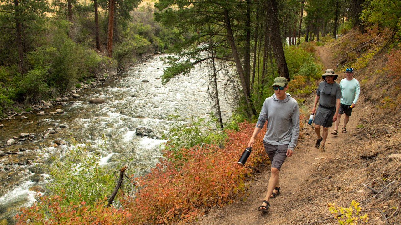 People hiking on a trail along the Salmon River