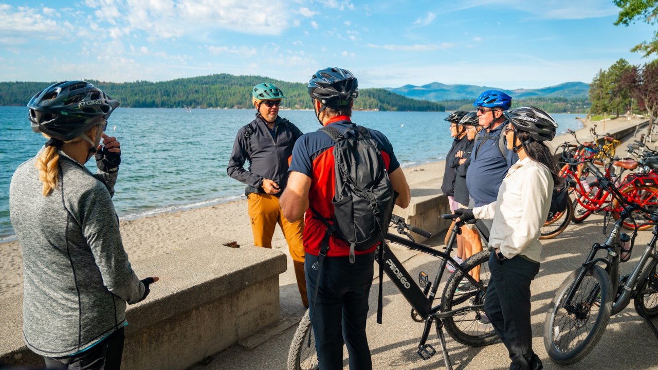 Guided biking group gathered by Lake Coeur d'Alene during an Idaho biking tour