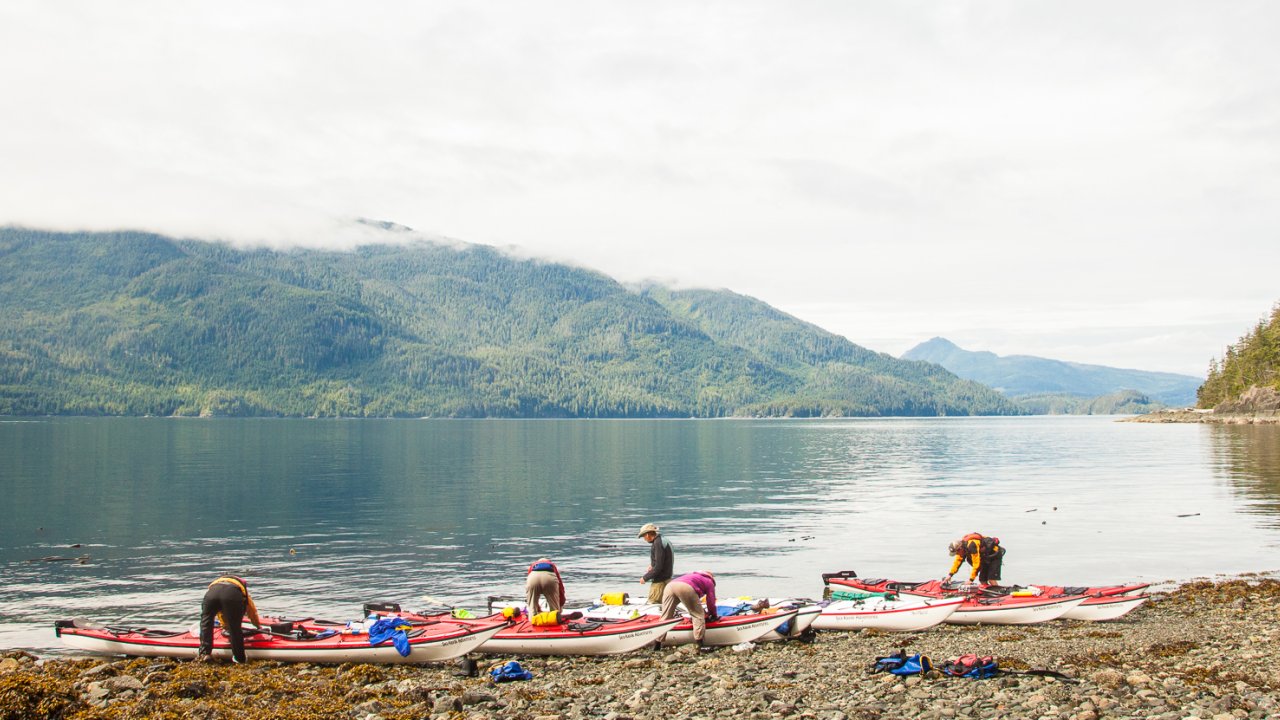 Kayakers packing their boats before a day on the water in Johnstone Strait