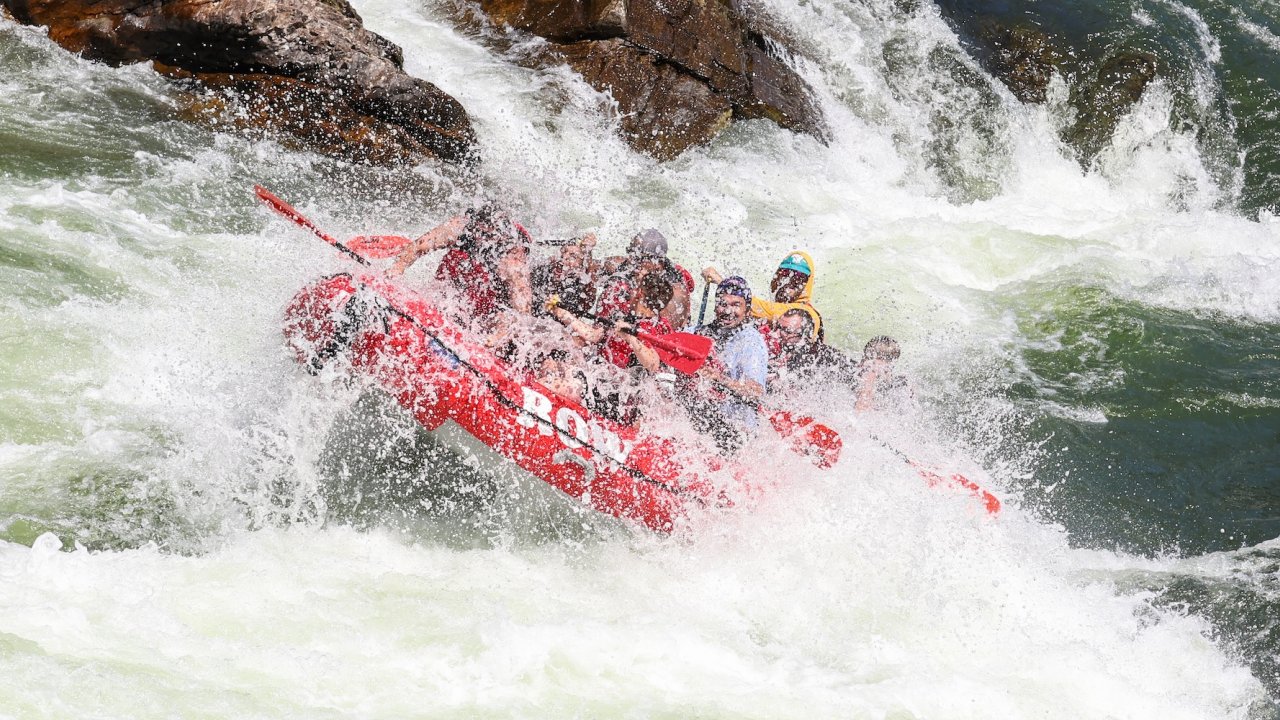 ROW Adventures raft going through a large rapid in Montana.