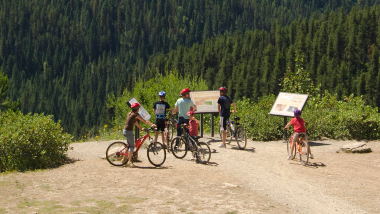 Side view shot of bikers on the Hiawatha Trail in Northern Idaho