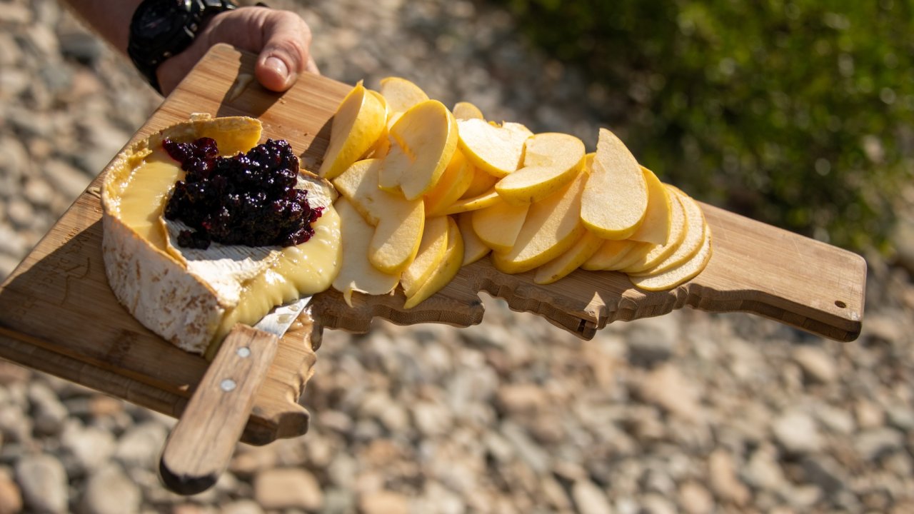 Backcountry gourmet snack of brie cheese, apples, and huckleberry jam on Idaho hiking tour