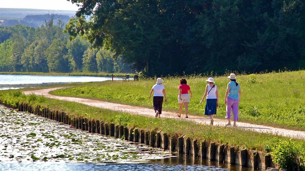 people walking along french canal