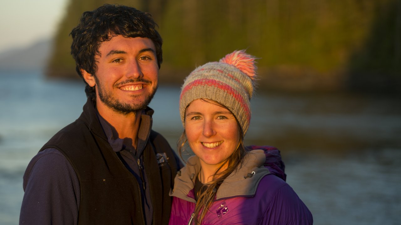 Guests smile for a photo at their beachside camp in British Columbia