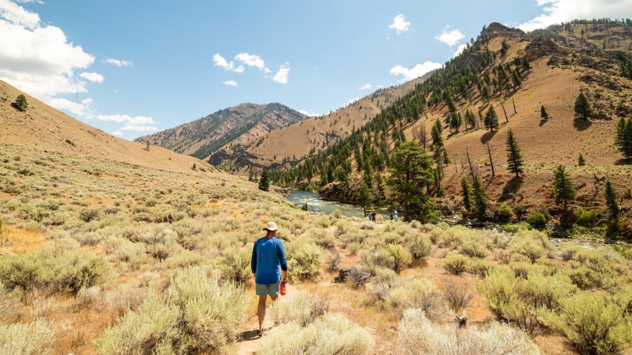 Hiker on Middle Fork Salmon River trail during an Idaho hiking tour with raft support