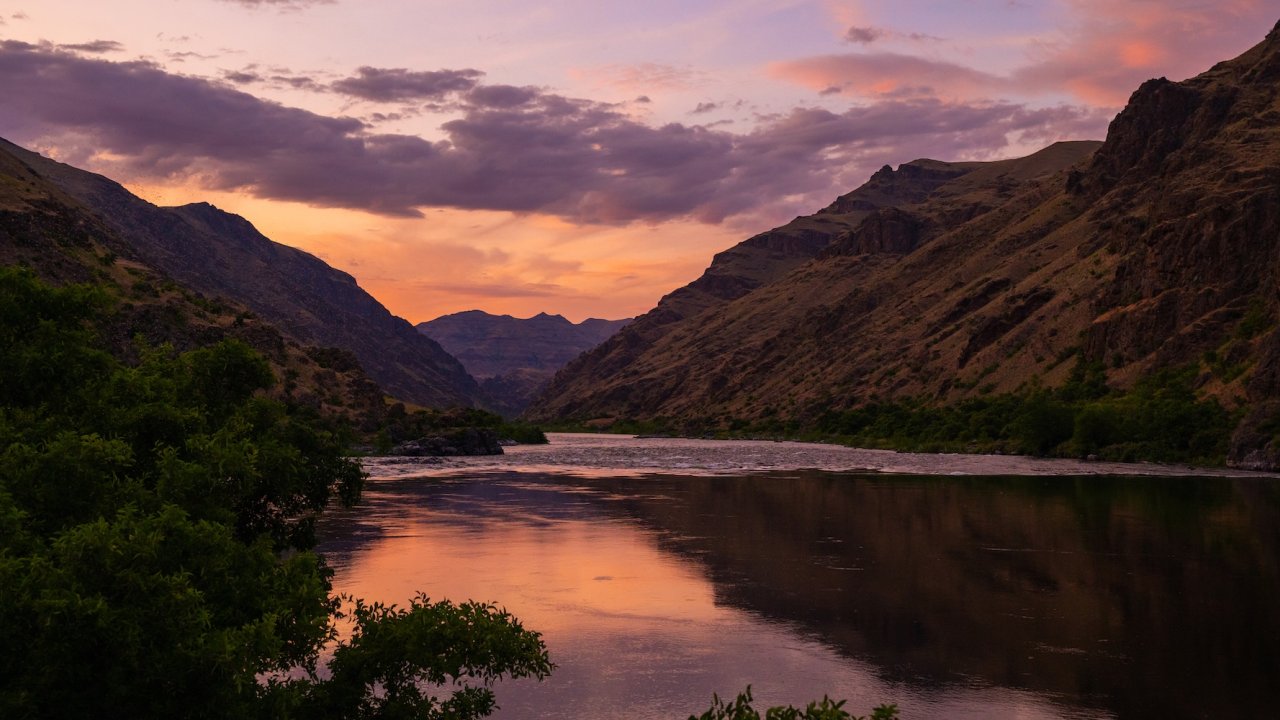 Peaceful sunset over the Salmon River canyon in Idaho, a serene setting for wellness retreats and mindful travel.