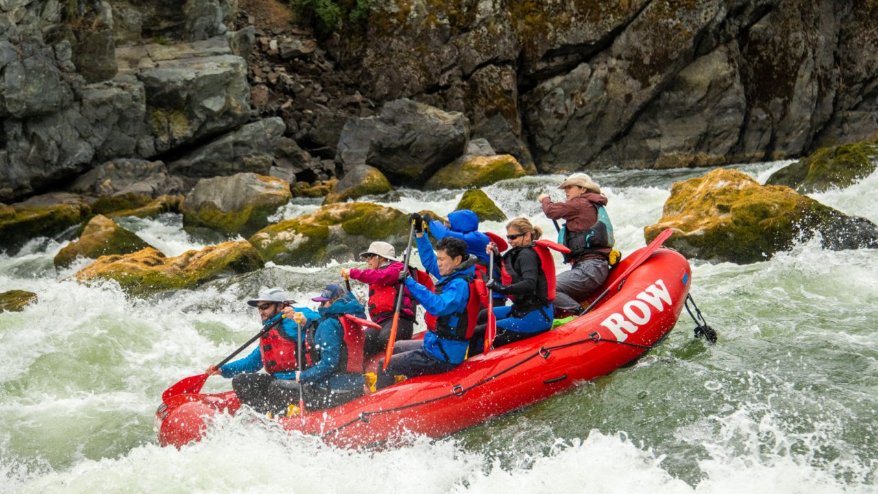 red paddle raft on the snake river in idaho going through a rapid