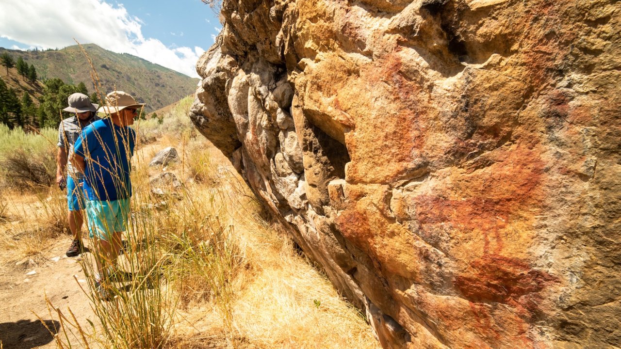 Hikers exploring ancient petroglyphs along the Middle Fork Salmon River in Idaho