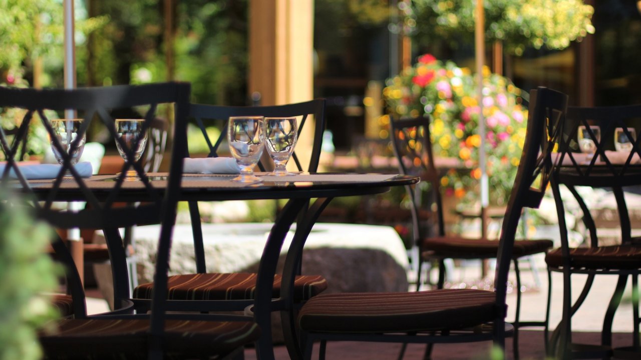 Elegant outdoor dining setup surrounded by flowers, reflecting the relaxed culinary experiences on the Oregon bike tour