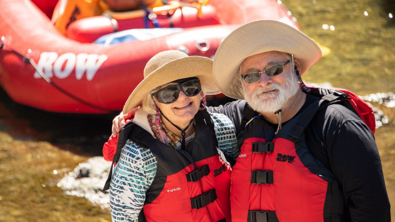 couple standing in front of red raft