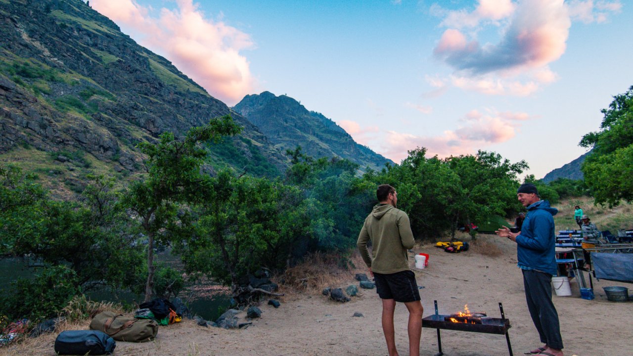 people around the campfire in idaho along snake river