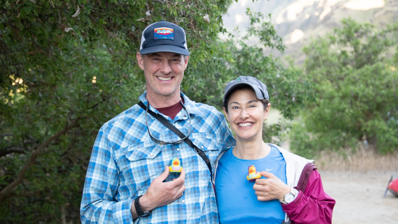people holding yellow ducks