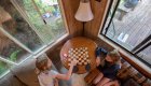Guests playing a game of chess looking out the window overlooking the Rogue River