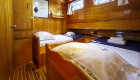 Two twin beds configured in a small room aboard a small chartered yacht in Turkey