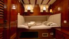 cabin with wood paneling and bed on board a yacht