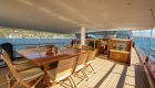wooden dining table on deck of yacht