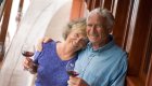 couple on board yacht deck with wine 