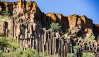 Basalt columns surrounded by desert greenery