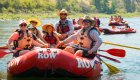 Family smiling on a red whitewater raft in Idaho