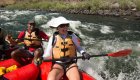 Woman smiling while paddling through a whitewater rapid on the Lower Salmon River