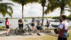 Group of guests next to their bikes enjoying a snack and view of the water in Cuba