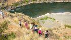 Birdseye view of people hiking along a trail along the Snake River