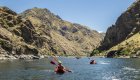 People in inflatable kayaks paddling on the Snake River in Idaho on a sunny summer day