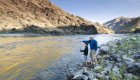 A dad and son fishing together on the Salmon River in Idaho just before sunset