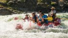 A family paddling through a splashy whitewater rapid on the Lower Salmon River