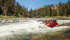 People on a whitewater raft going through a rapid on the Middle Fork Salmon River