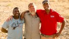 three men standing arm and arm in namibia