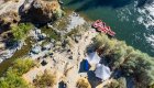Birds eye view of a camping set up on a sandy beach along the Rogue River