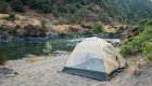 Tent set up on a sandy campsite along the Rogue River in Oregon