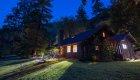 One of the Rogue River lodges lit up at night 